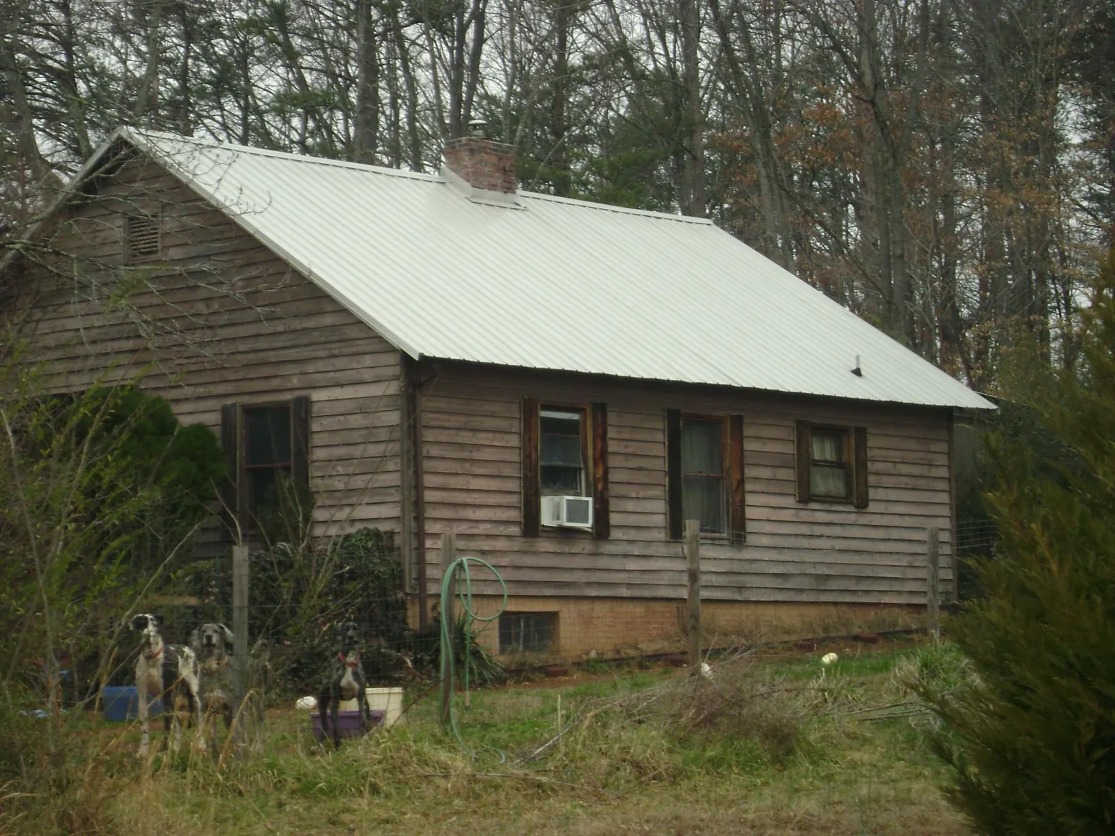 White metal roof on an old wood sided farmhouse, from a Asphalt Shingle Roof Repair job in Crawford